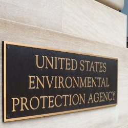 A bronze plaque on a sandstone wall indicating that this building houses the Environmental Protection Agency of the United States