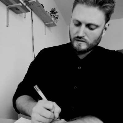 J Aaron Griffiths writes at his desk