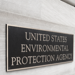 A bronze plaque on a sandstone wall indicating that this building houses the Environmental Protection Agency of the United States